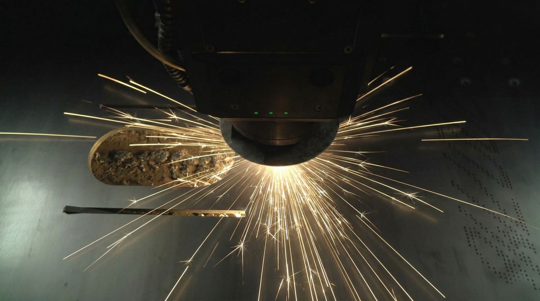 Laser cutting head cutting sheet metal, top-down view Laser cutting head cutting sheet metal, top-down view